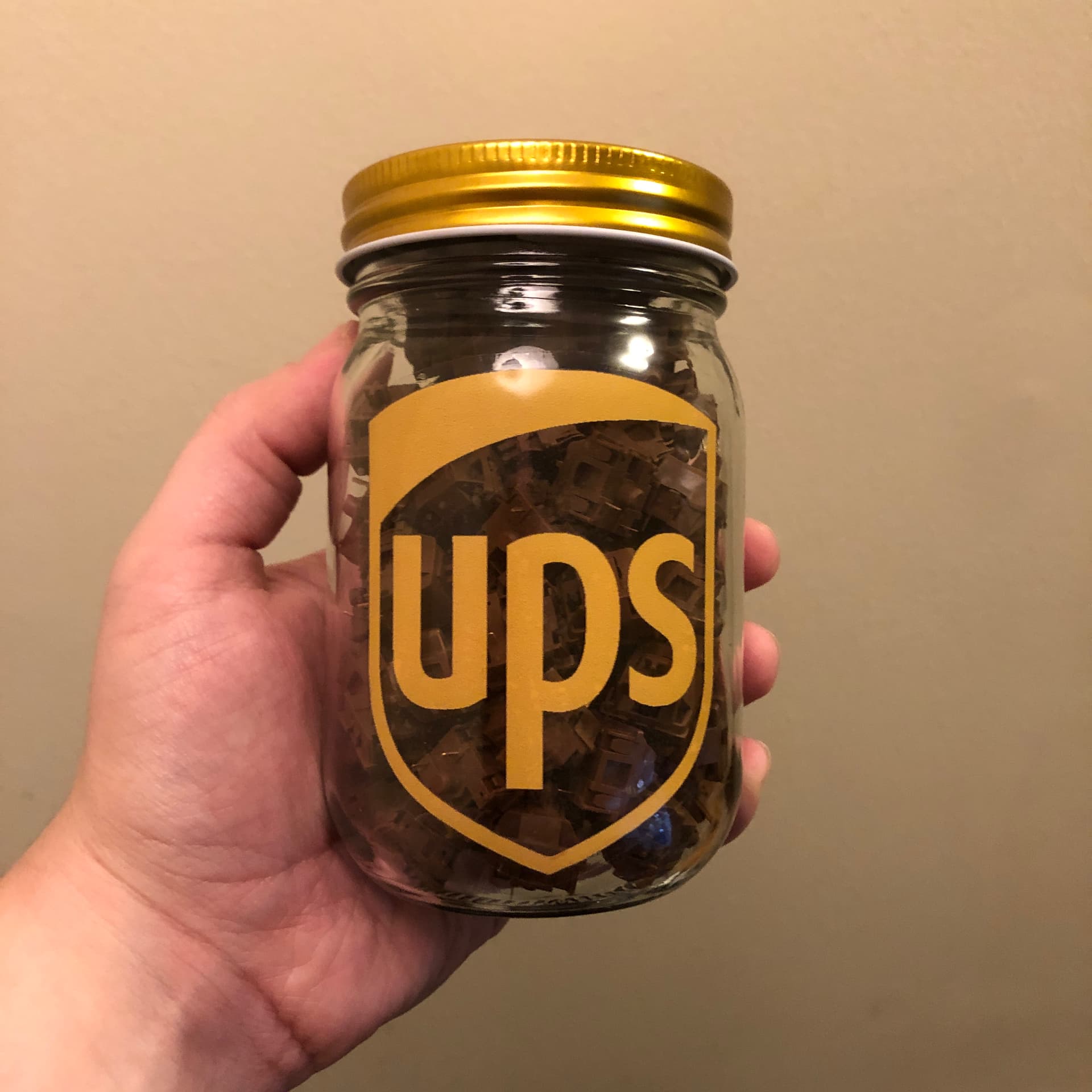 A jar of Akko POM Browns with a UPS sticker because brown